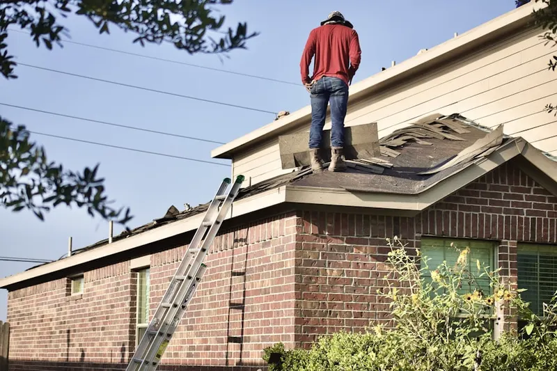 Professional roofer working on a residential roof in Union Springs